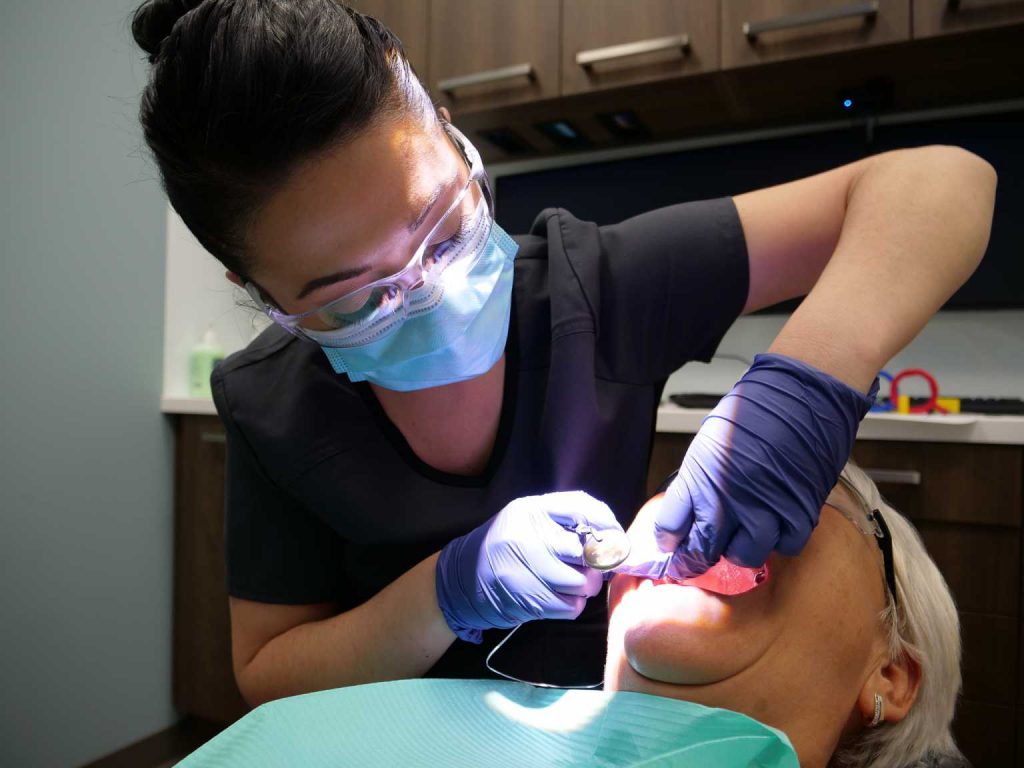 Local Calgary dental hygienist taking care of patients clean teeth